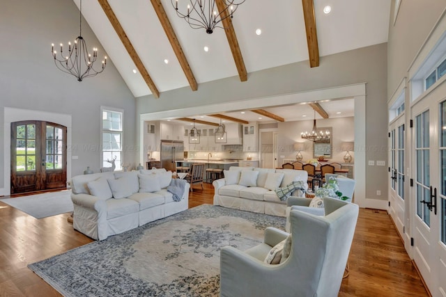 397 Blue Water Pointe Dr, Jasper, AL 35504 - living room featuring high vaulted ceiling, wood finished floors, french doors, and an inviting chandelier