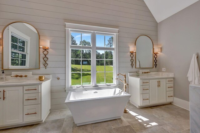 397 Blue Water Pointe Dr, Jasper, AL 35504 - bathroom featuring a soaking tub, lofted ceiling, a sink, and two vanities