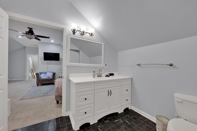 full bath with baseboards, toilet, vanity, a ceiling fan, and vaulted ceiling