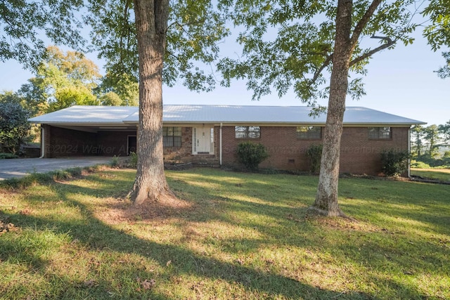 ranch-style house featuring an attached carport, driveway, a front lawn, and brick siding