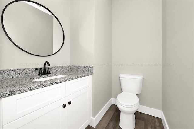 3195 County Road 51, Bremen, AL 35033 - half bathroom with toilet, wood finished floors, baseboards, and vanity