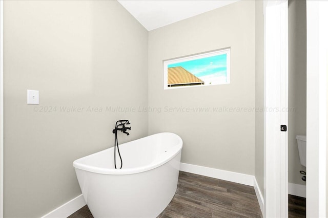 3195 County Road 51, Bremen, AL 35033 - bathroom with a soaking tub, baseboards, and wood finished floors