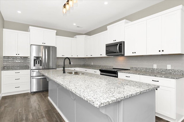 3195 County Road 51, Bremen, AL 35033 - kitchen featuring light stone counters, a sink, appliances with stainless steel finishes, dark wood finished floors, and decorative backsplash