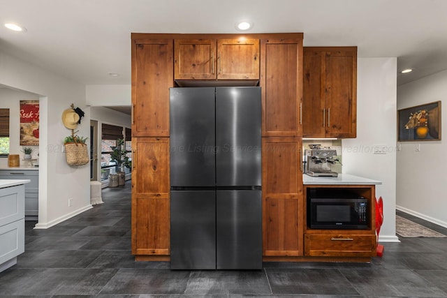 400 N Crest Cir, Jasper, AL 35501 - kitchen featuring freestanding refrigerator, black microwave, baseboards, recessed lighting, and brown cabinets