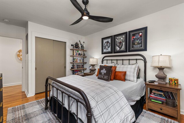 400 N Crest Cir, Jasper, AL 35501 - bedroom with wood finished floors, a closet, ceiling fan, and baseboards