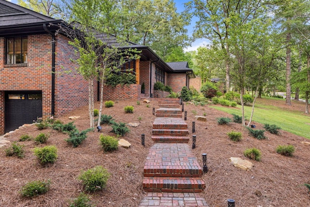 400 N Crest Cir, Jasper, AL 35501 - view of home's exterior with brick siding, an attached garage, and stairs