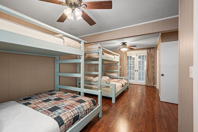 58 Lake Ln, Jasper, AL 35504 - bedroom featuring crown molding, a textured ceiling, wood finished floors, french doors, and wooden walls