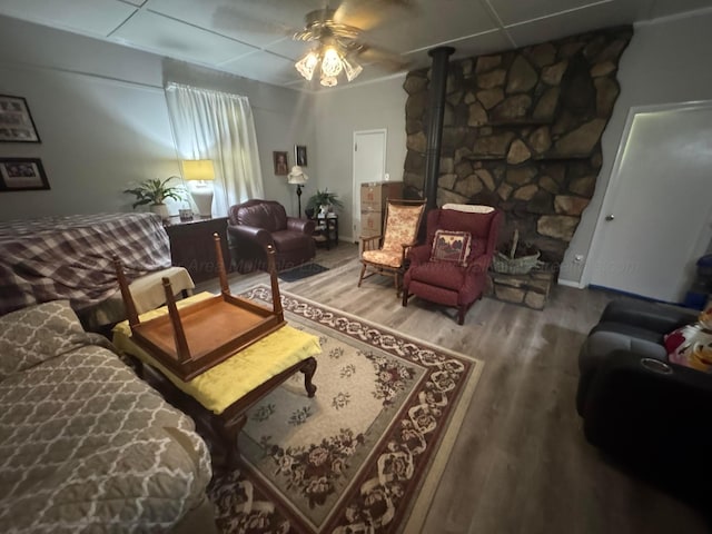 1107 Forest Rd, Jasper, AL 35504 - living room featuring a ceiling fan, a wood stove, and wood finished floors