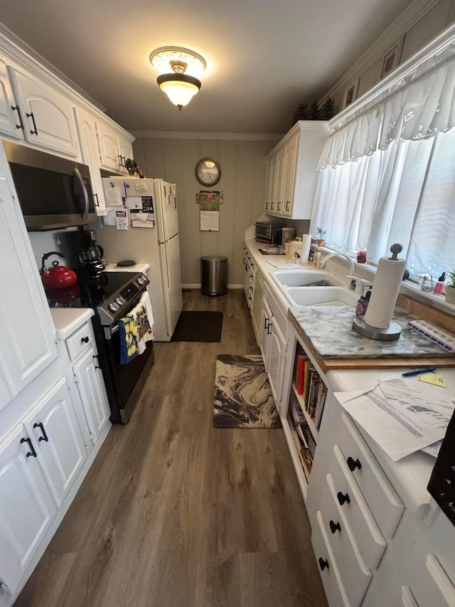 1107 Forest Rd, Jasper, AL 35504 - kitchen featuring stainless steel microwave, range with electric cooktop, dark wood-style floors, light countertops, and white cabinets