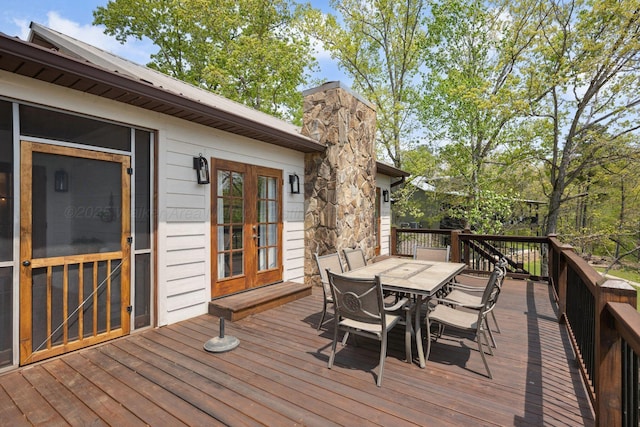 deck featuring outdoor dining area and french doors