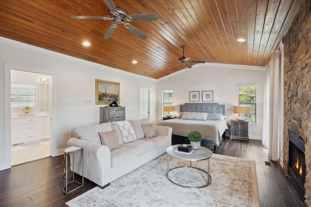 bedroom with dark wood-style floors, connected bathroom, vaulted ceiling, baseboards, and wood ceiling
