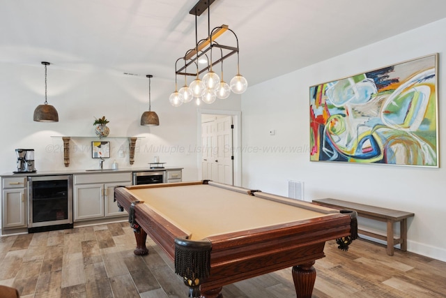 recreation room featuring wine cooler, billiards, bar area, and light wood-style floors