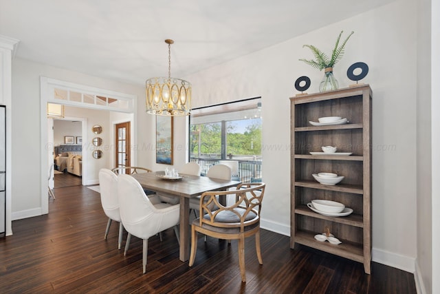 dining area with a chandelier, dark wood-style floors, and baseboards