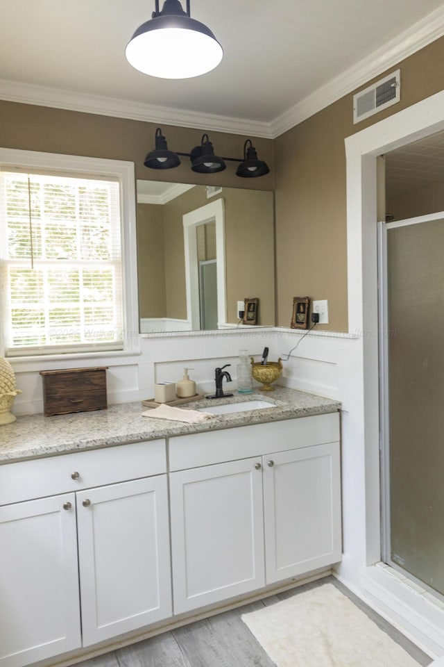 605 W 6th St, Jasper, AL 35501 - bathroom with a shower stall, vanity, ornamental molding, and wood finished floors