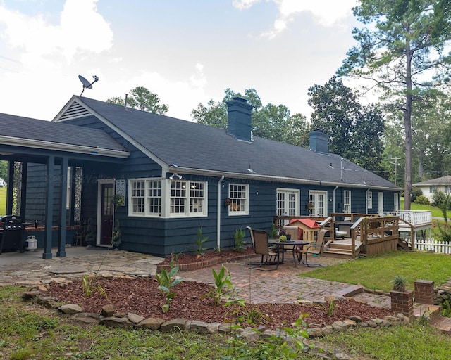 605 W 6th St, Jasper, AL 35501 - rear view of property with a patio, a wooden deck, a chimney, and a lawn