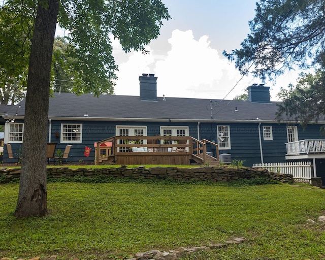 605 W 6th St, Jasper, AL 35501 - rear view of house with a deck, a chimney, and a lawn