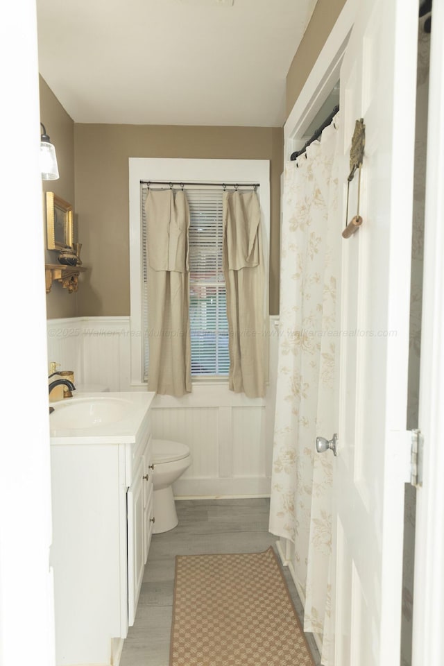 605 W 6th St, Jasper, AL 35501 - bathroom with vanity, a wainscoted wall, and a decorative wall