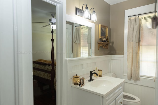 605 W 6th St, Jasper, AL 35501 - bathroom featuring a decorative wall, vanity, ensuite bath, ceiling fan, and wainscoting