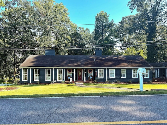 605 W 6th St, Jasper, AL 35501 - ranch-style home with a chimney, a front lawn, and covered porch