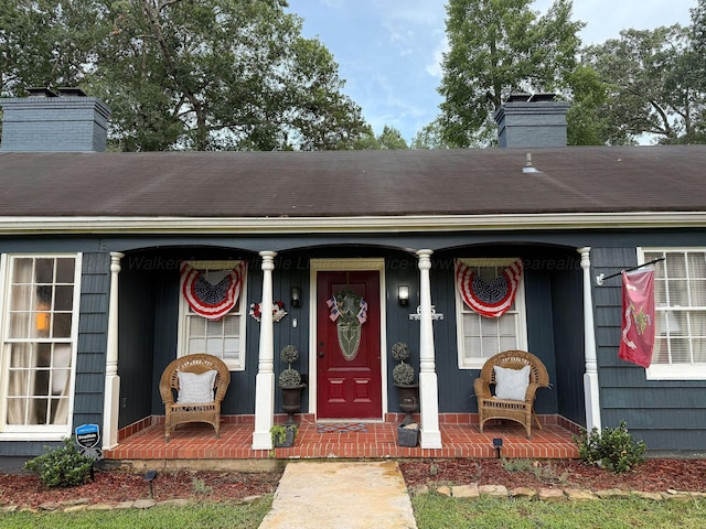 605 W 6th St, Jasper, AL 35501 - view of exterior entry featuring covered porch and a chimney