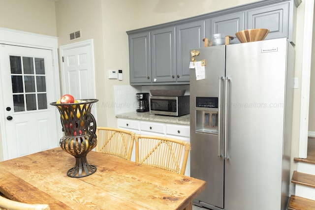 605 W 6th St, Jasper, AL 35501 - kitchen with stainless steel appliances, gray cabinets, and decorative backsplash