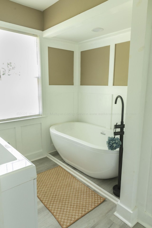 605 W 6th St, Jasper, AL 35501 - bathroom featuring wood finished floors, a freestanding bath, and vanity