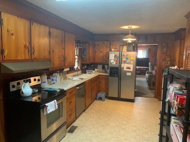 kitchen featuring sink, pendant lighting, and appliances with stainless steel finishes