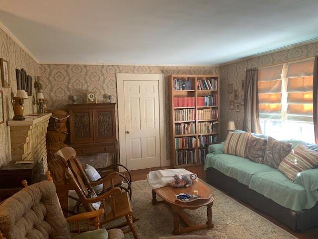 living room with a stone fireplace and wood-type flooring