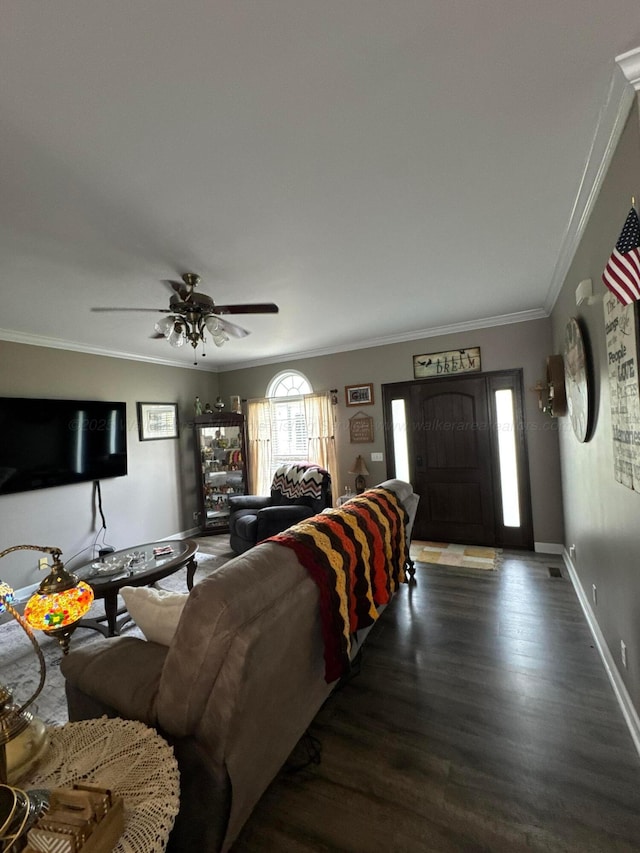 living area with a ceiling fan, baseboards, crown molding, and wood finished floors