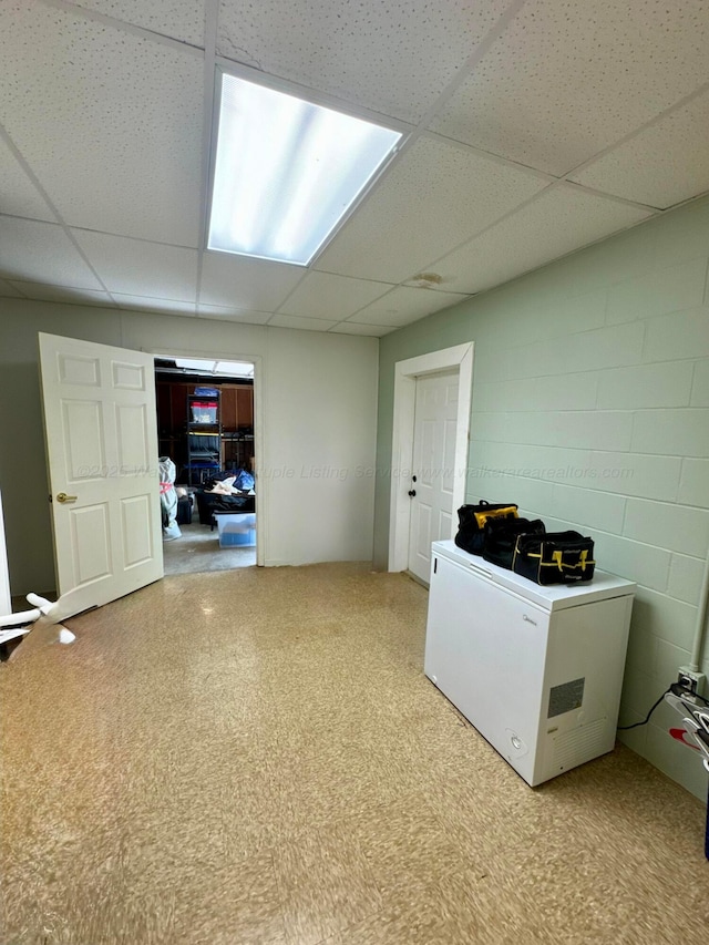 washroom featuring concrete block wall and carpet flooring