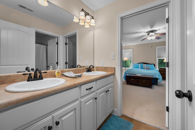 1528 Sipsey Rd, Double Springs, AL 35553 - bathroom featuring double vanity, ensuite bath, ceiling fan, and wood finished floors