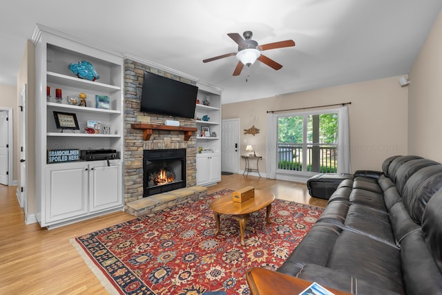1528 Sipsey Rd, Double Springs, AL 35553 - living room featuring a ceiling fan, a fireplace, light wood-type flooring, and built in shelves