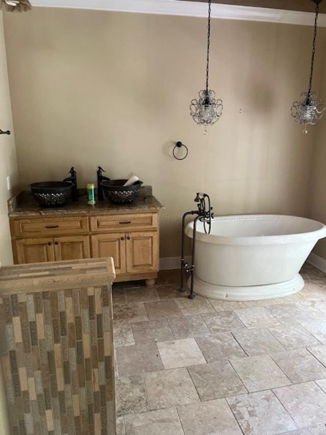 130 Quail Run Dr, Winfield, AL 35594 - full bathroom with stone tile flooring, crown molding, baseboards, and a freestanding bath