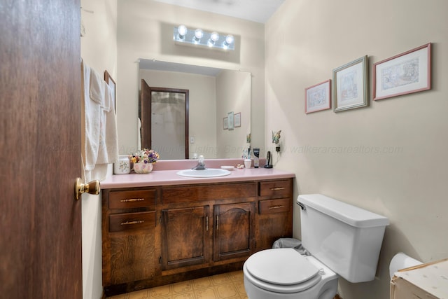 bathroom featuring toilet and vanity