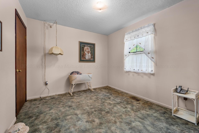 carpeted bedroom featuring baseboards, visible vents, and a textured ceiling