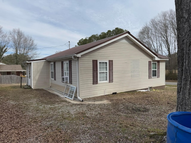 view of property exterior with cooling unit and fence