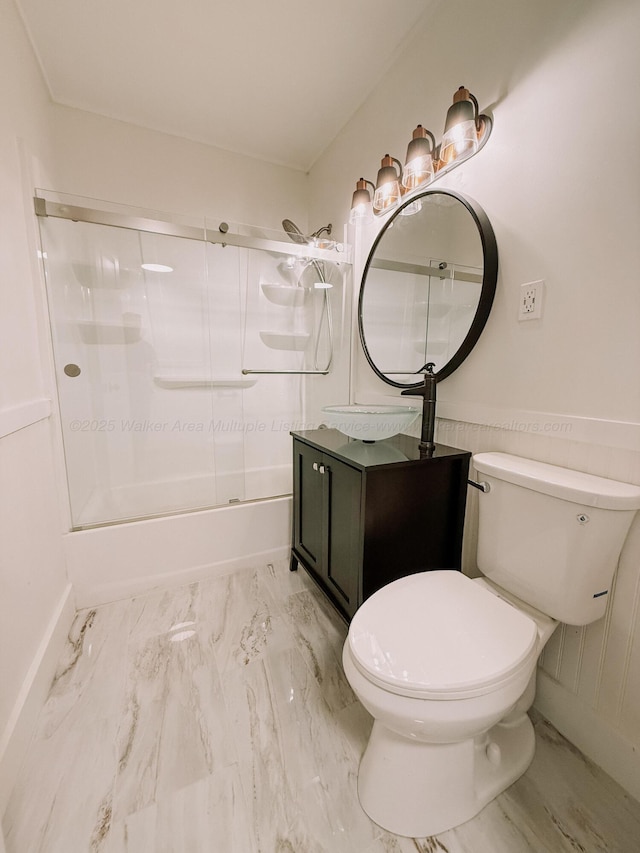 2301 E 20th Ave, Jasper, AL 35501 - bathroom featuring marble finish floors, bath / shower combo with glass door, vanity, toilet, and baseboards