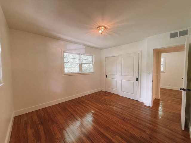 2301 E 20th Ave, Jasper, AL 35501 - unfurnished bedroom with dark wood finished floors, baseboards, and a closet