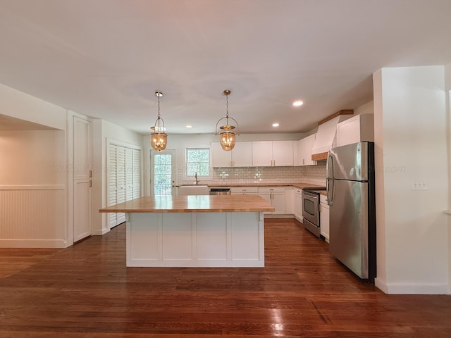 2301 E 20th Ave, Jasper, AL 35501 - kitchen with appliances with stainless steel finishes, wooden counters, a kitchen island, white cabinets, and dark wood-style flooring