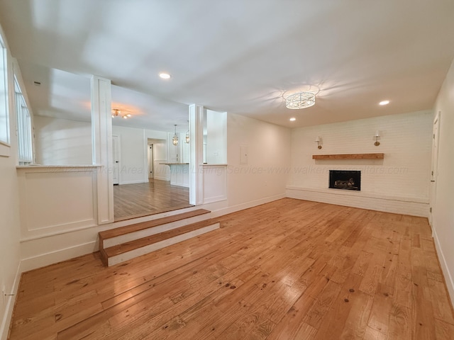 2301 E 20th Ave, Jasper, AL 35501 - unfurnished living room featuring a fireplace, light wood-type flooring, recessed lighting, and baseboards