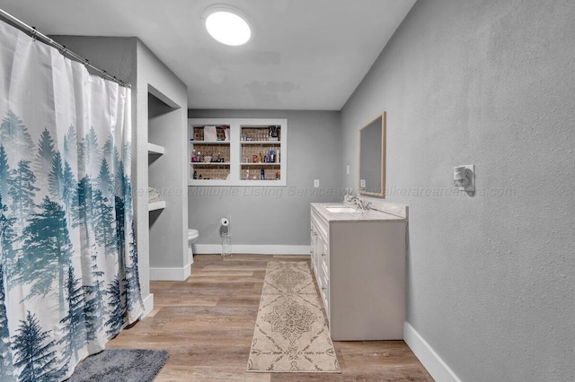 809 W 15th St, Jasper, AL 35501 - full bath with vanity, a textured wall, wood finished floors, and a shower with curtain