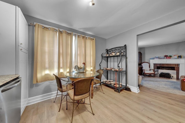 809 W 15th St, Jasper, AL 35501 - dining room featuring light wood-style floors and a fireplace
