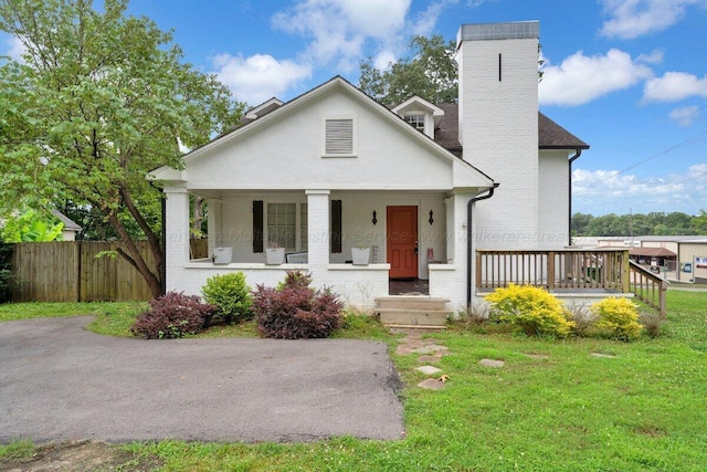 809 W 15th St, Jasper, AL 35501 - view of front of house featuring a chimney, a porch, and brick siding