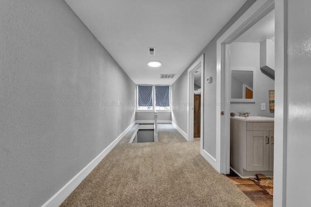 809 W 15th St, Jasper, AL 35501 - hallway featuring a textured wall and carpet