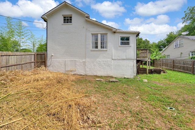 809 W 15th St, Jasper, AL 35501 - rear view of house featuring a fenced backyard, brick siding, and a wooden deck