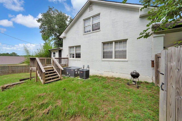 809 W 15th St, Jasper, AL 35501 - back of property with a wooden deck, a fenced backyard, and brick siding