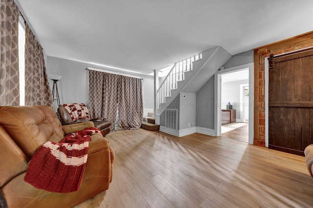 809 W 15th St, Jasper, AL 35501 - living area featuring stairs, light wood-type flooring, and a barn door