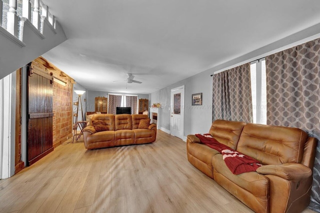 809 W 15th St, Jasper, AL 35501 - living room with light wood-style flooring, a ceiling fan, and a fireplace