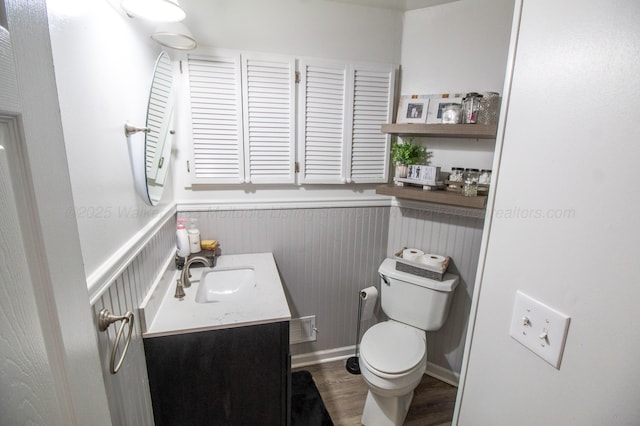 1602 27th St, Haleyville, AL 35565 - bathroom with vanity, wainscoting, and wood finished floors
