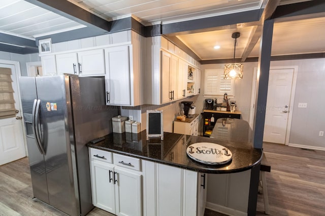1602 27th St, Haleyville, AL 35565 - kitchen with stainless steel refrigerator with ice dispenser, beamed ceiling, light wood-type flooring, a breakfast bar, and white cabinets